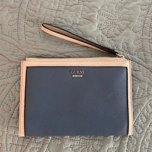 Guess wristlet bag with interior pockets.